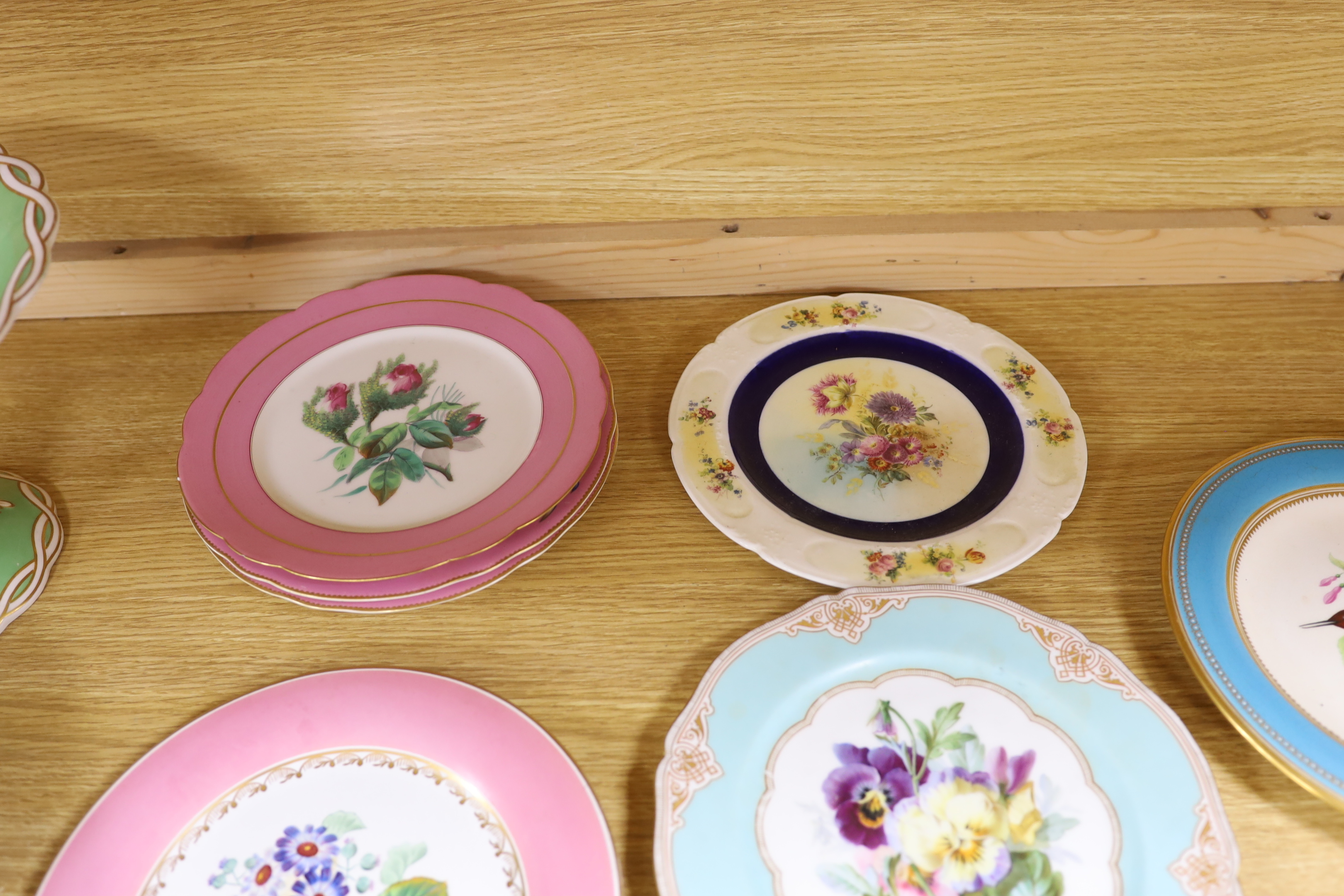 An English floral decorated comport and nine dessert plates, together with ten mixed floral patterned plates, largest 28cm in diameter